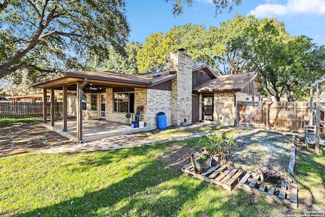 back of house featuring a yard and a patio