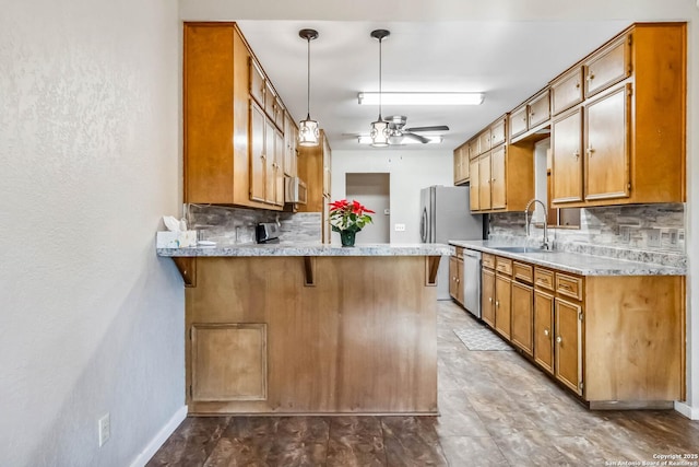 kitchen with stainless steel dishwasher, decorative backsplash, kitchen peninsula, and sink