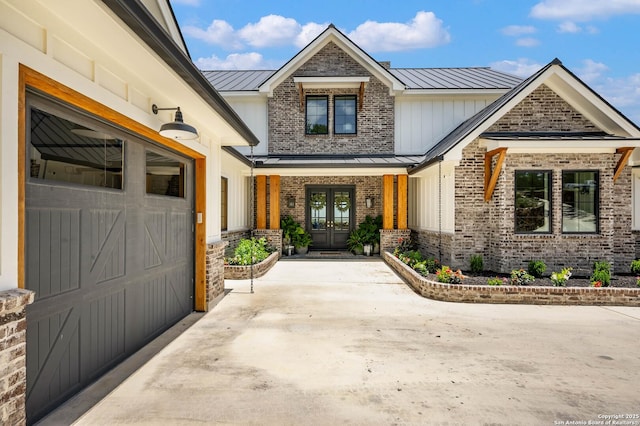 view of exterior entry featuring french doors and a garage