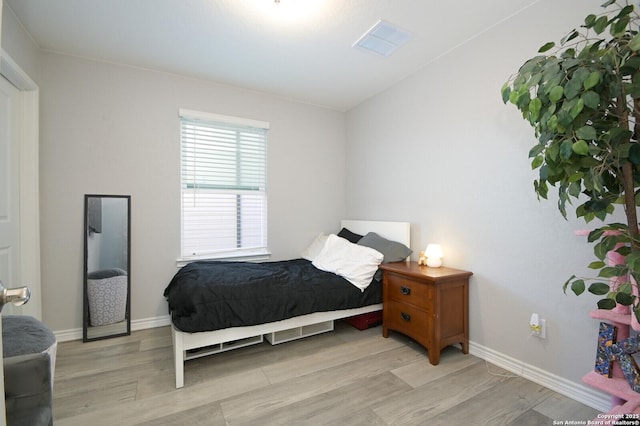 bedroom with light hardwood / wood-style flooring