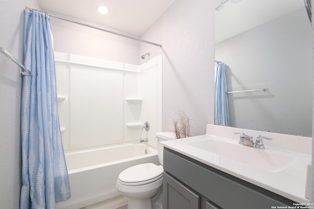 full bathroom featuring vanity, toilet, and shower / tub combo