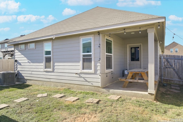 back of property featuring a lawn and a patio