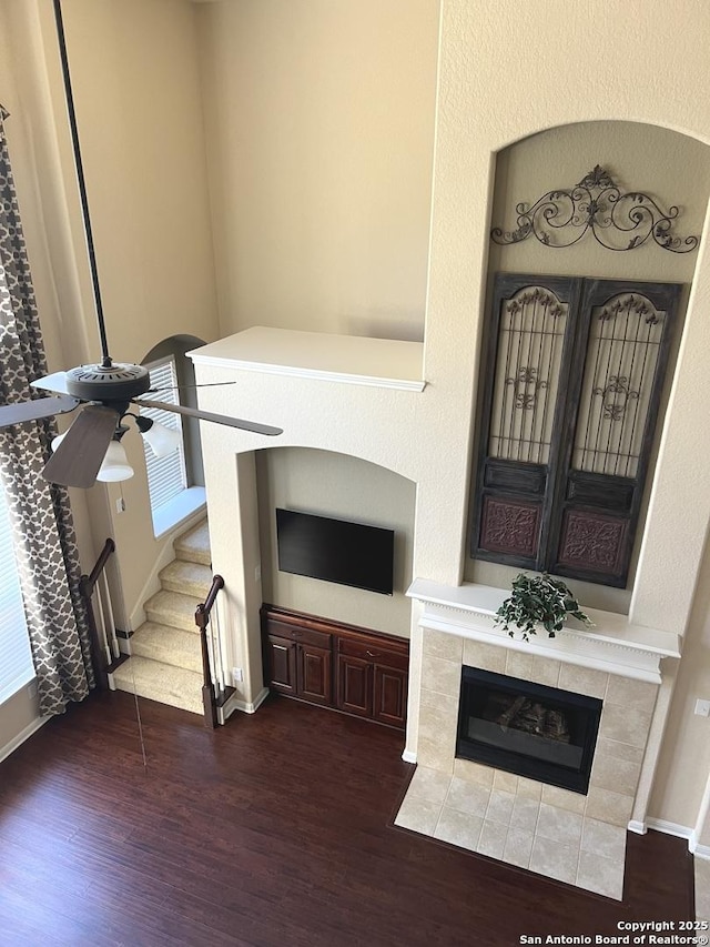 living room with ceiling fan, dark hardwood / wood-style floors, and a fireplace