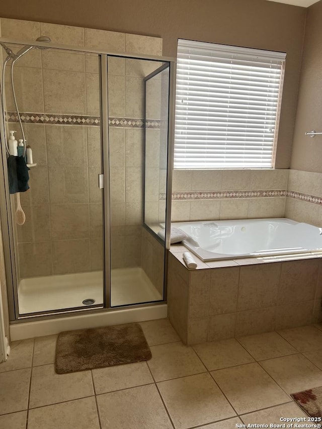 bathroom featuring tile patterned floors and independent shower and bath