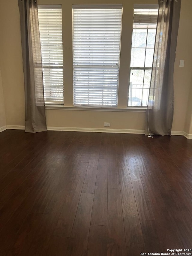 spare room featuring dark wood-type flooring