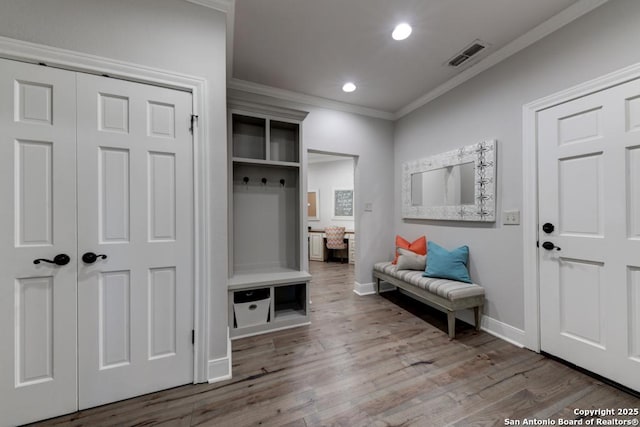 mudroom featuring crown molding and hardwood / wood-style floors