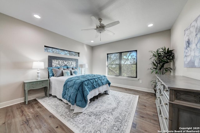 bedroom with dark hardwood / wood-style flooring and ceiling fan