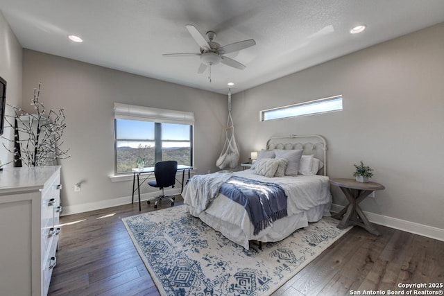 bedroom with dark hardwood / wood-style flooring and ceiling fan