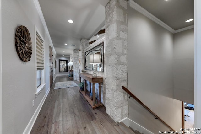 corridor with hardwood / wood-style flooring and ornamental molding