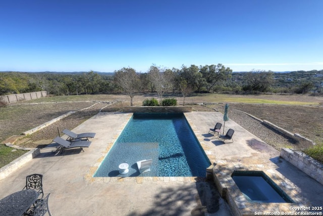 view of swimming pool featuring a patio and an in ground hot tub