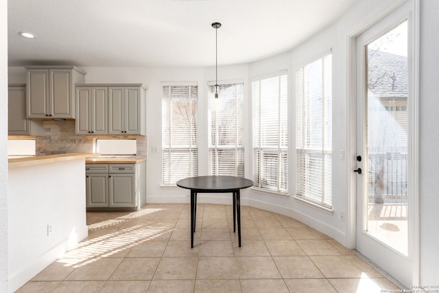 unfurnished dining area with light tile patterned floors and plenty of natural light