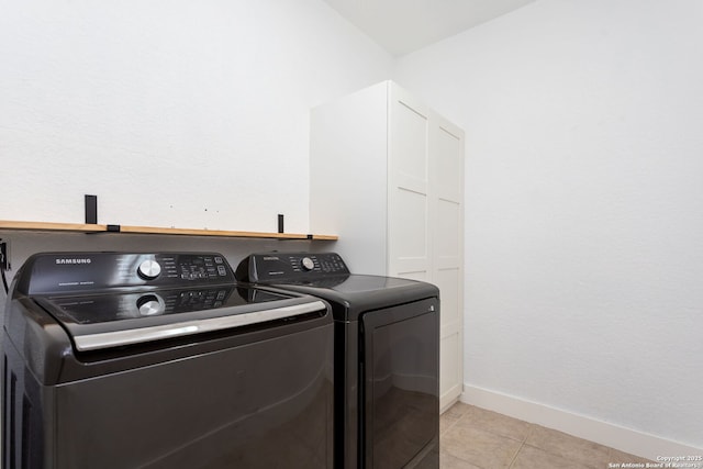 laundry room featuring independent washer and dryer and light tile patterned floors