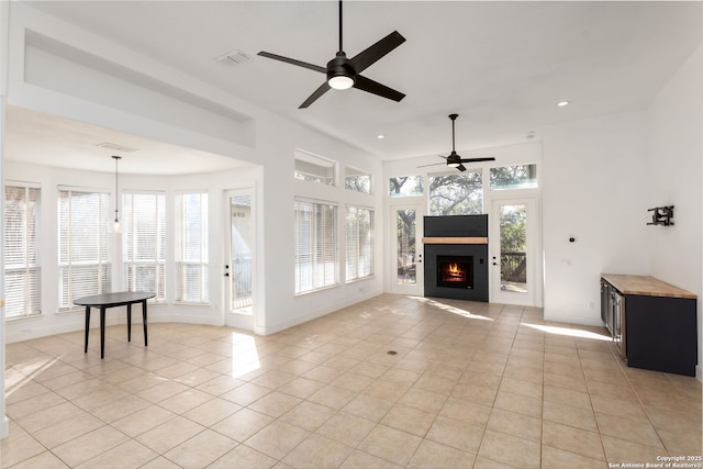 unfurnished living room featuring ceiling fan and light tile patterned flooring