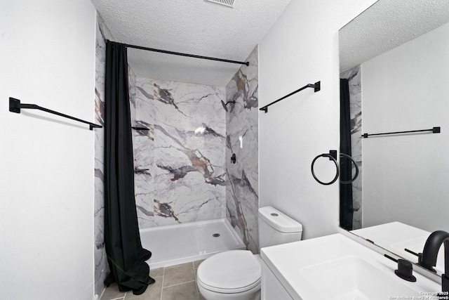 bathroom featuring vanity, tile patterned floors, a shower with curtain, toilet, and a textured ceiling