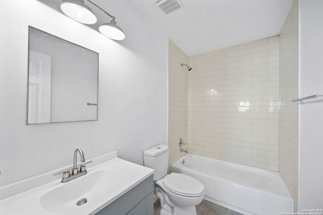 full bathroom featuring vanity, toilet, and tiled shower / bath