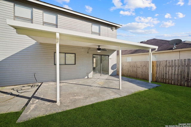 back of house with a lawn, ceiling fan, and a patio area