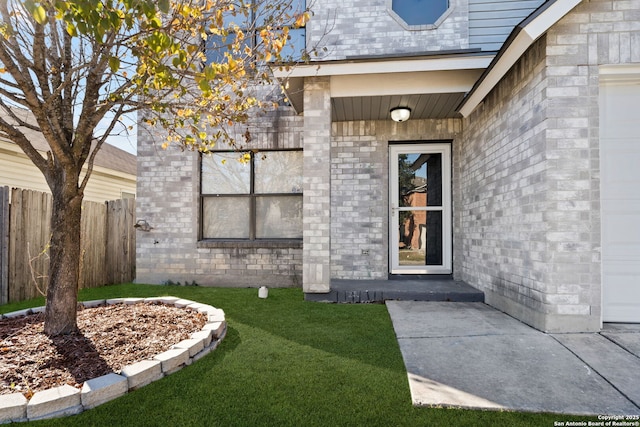 doorway to property with a lawn