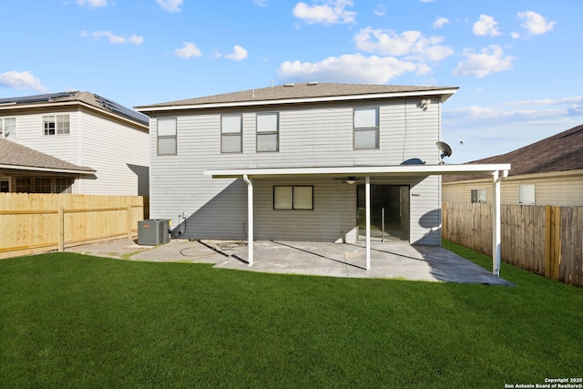 rear view of property featuring a patio area, a yard, and central AC