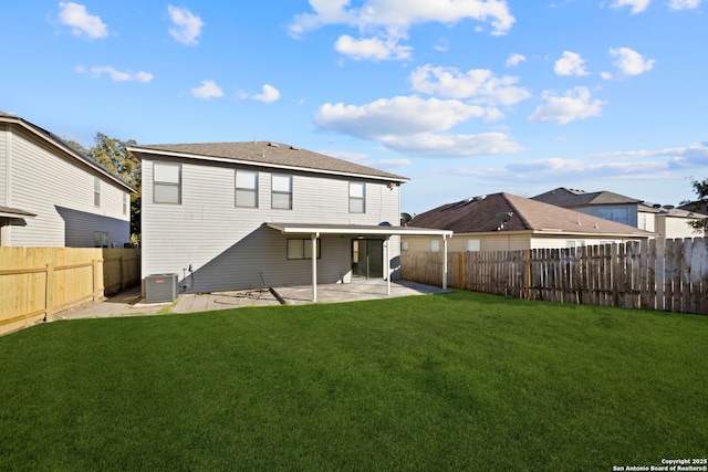 rear view of property featuring a yard, a patio, and central air condition unit