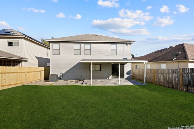 rear view of property featuring a patio, central air condition unit, and a lawn