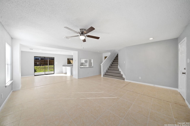 unfurnished living room with light tile patterned floors, a textured ceiling, and ceiling fan