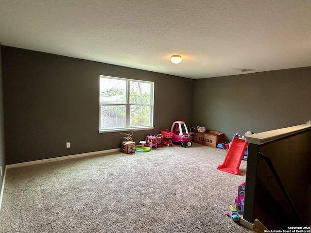 rec room with carpet flooring and a textured ceiling