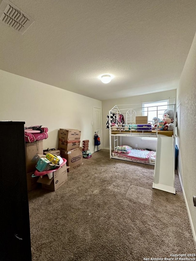 bedroom featuring carpet and a textured ceiling