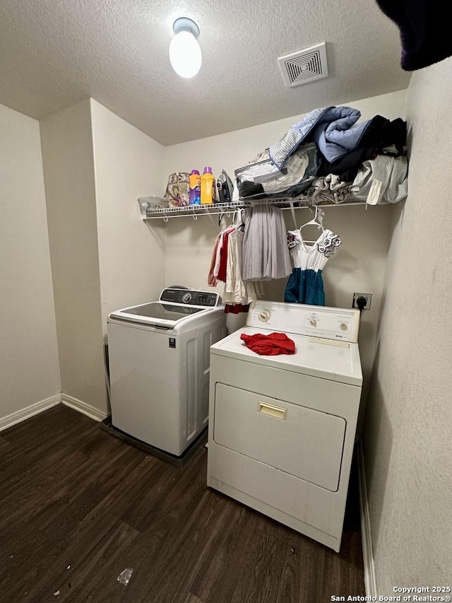 washroom featuring washer and clothes dryer, dark hardwood / wood-style flooring, and a textured ceiling