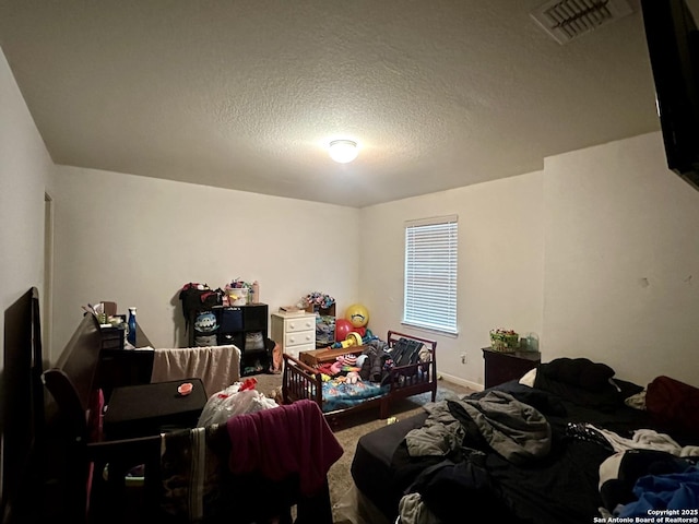 carpeted bedroom featuring a textured ceiling