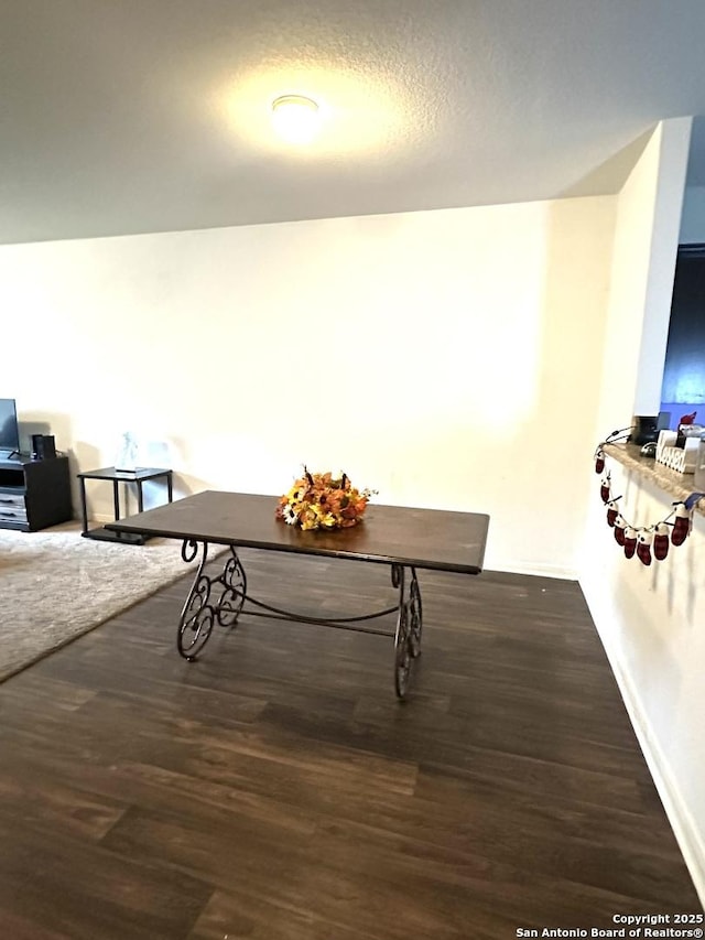 interior space with a textured ceiling and dark wood-type flooring