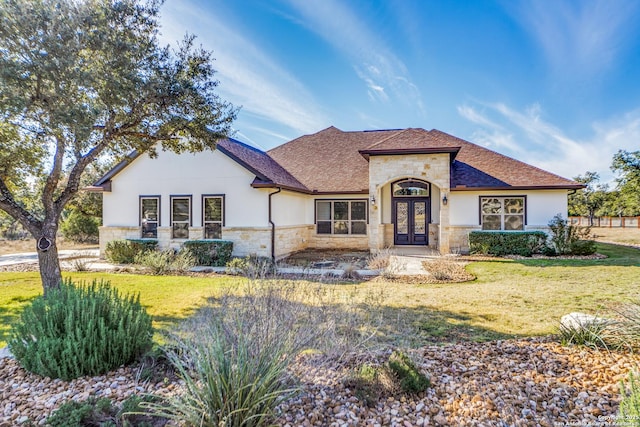 view of front facade featuring french doors and a front yard