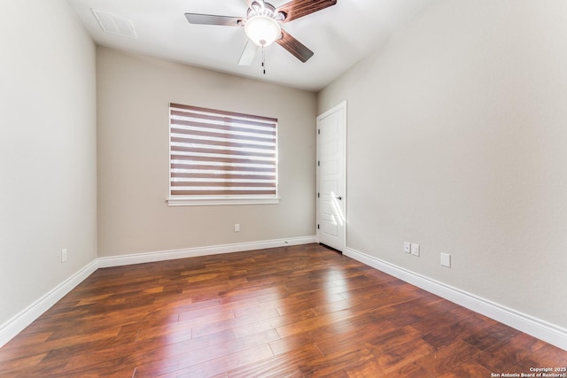 spare room with ceiling fan and dark hardwood / wood-style floors