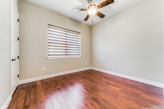 spare room featuring dark hardwood / wood-style floors and ceiling fan