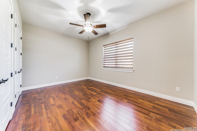 unfurnished bedroom with ceiling fan and dark hardwood / wood-style flooring