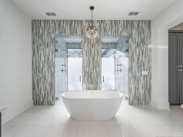 bathroom featuring tile patterned flooring, tile walls, independent shower and bath, and a notable chandelier