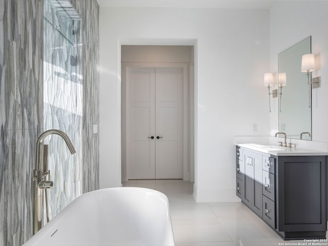 bathroom featuring tile patterned flooring, vanity, and a tub