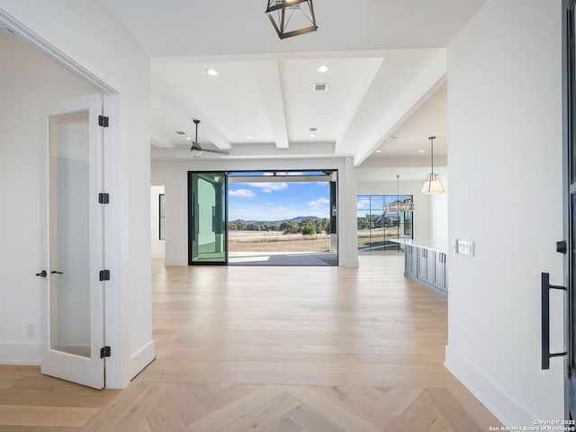 corridor featuring beamed ceiling and light parquet floors