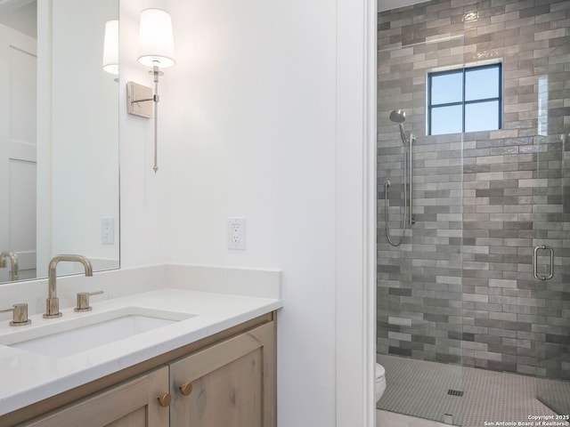 bathroom featuring vanity, toilet, and walk in shower