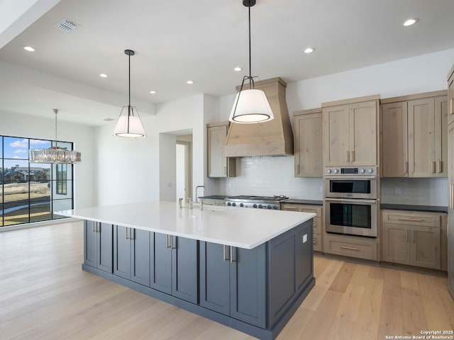 kitchen with decorative light fixtures, a spacious island, stainless steel double oven, and tasteful backsplash