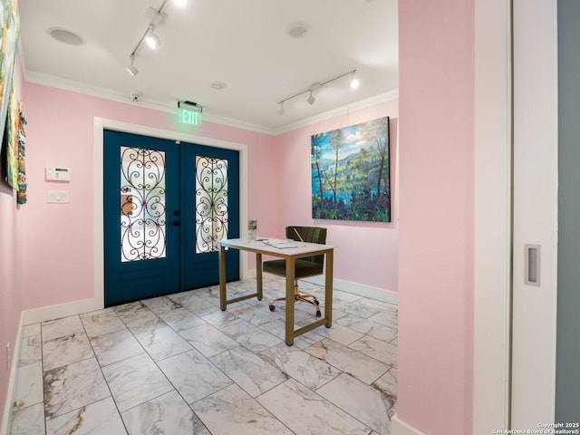 foyer featuring french doors, track lighting, and ornamental molding