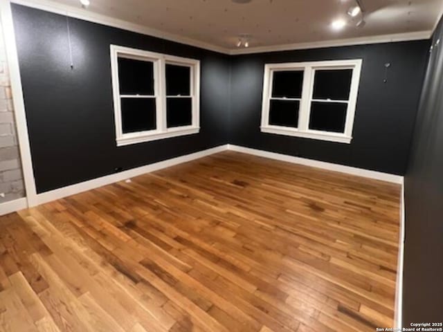 unfurnished room with crown molding and light hardwood / wood-style flooring