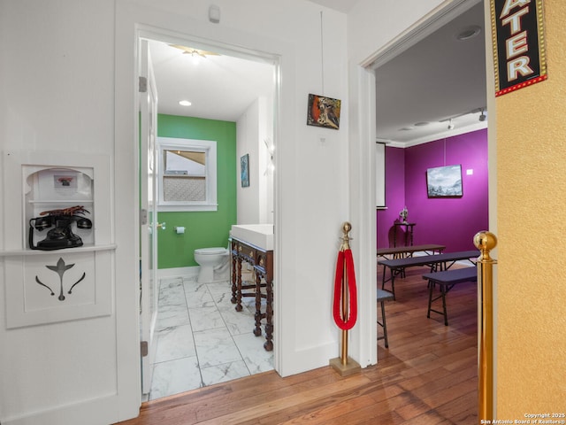 hallway with hardwood / wood-style flooring