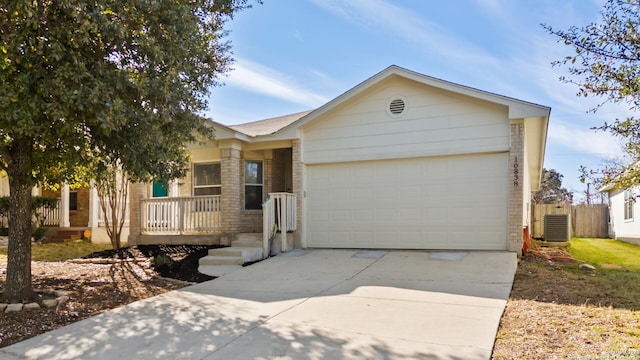 ranch-style home with a garage and cooling unit