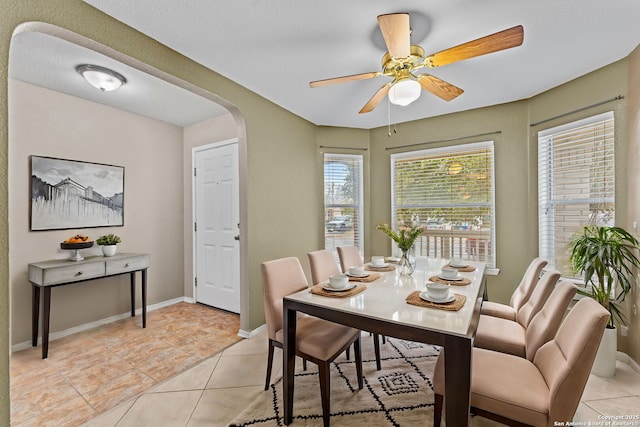 dining area with ceiling fan and light tile patterned floors