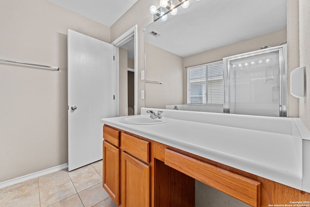 bathroom featuring vanity, tile patterned floors, and an enclosed shower