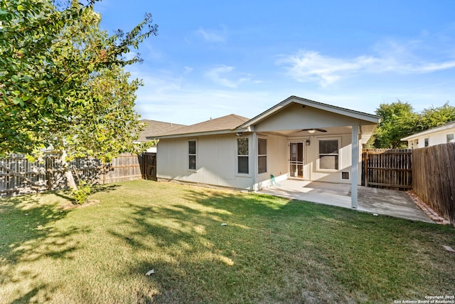 back of property featuring a yard, a patio, and ceiling fan