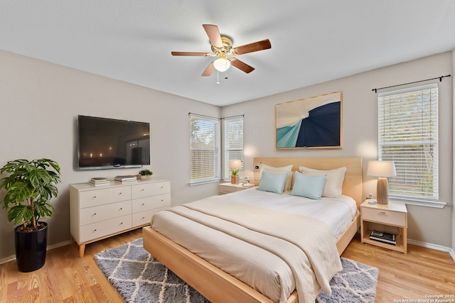 bedroom with ceiling fan and light hardwood / wood-style flooring