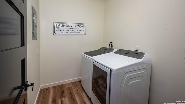 laundry area featuring separate washer and dryer and hardwood / wood-style floors