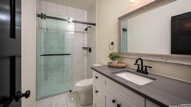 bathroom featuring vanity, toilet, and a shower with shower door