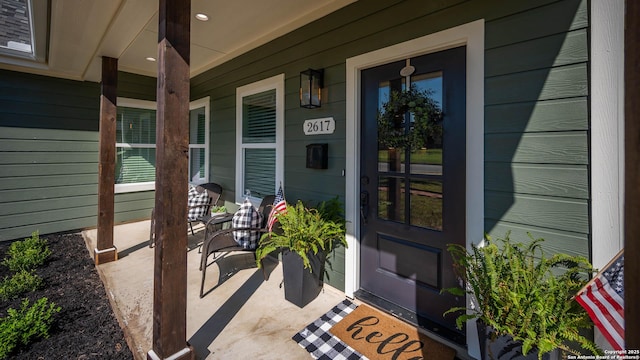 view of exterior entry featuring a porch